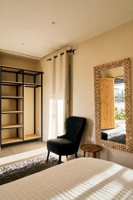 a bedroom with a chair and a mirror at Dar Meha in Marrakech