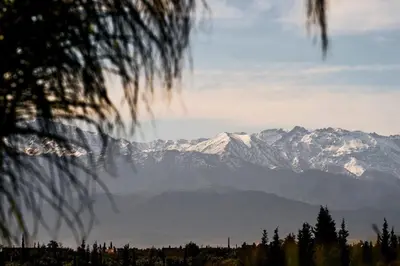 a view of a mountain range with snow covered mountains at Dar Meha in Marrakech
