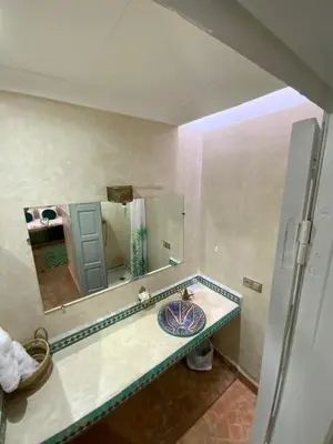 a bathroom with a sink and a mirror at Riad privatisé Magnolia in Marrakech