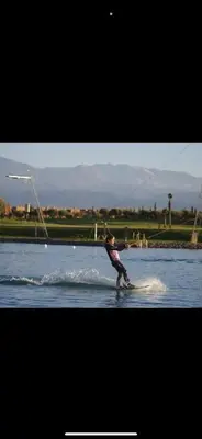 a person on a board in the water at Magnifique villa avec piscine chauffée in Marrakech
