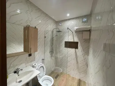 a bathroom with a shower and a toilet and a sink at Dar Chrif in Marrakech