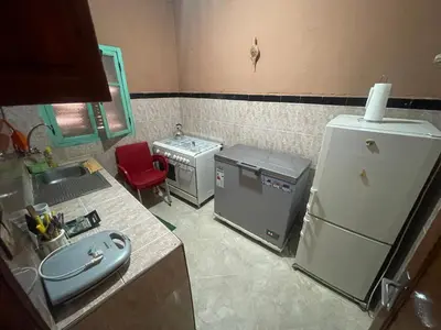 a small kitchen with two refrigerators and a sink at Dar Chrif in Marrakech