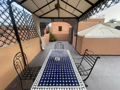 a table and chairs on a patio with a tent at Dar Chrif in Marrakech