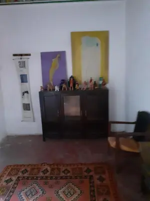 a living room with a cabinet and a rug at Maison authentique centre médina in Marrakech