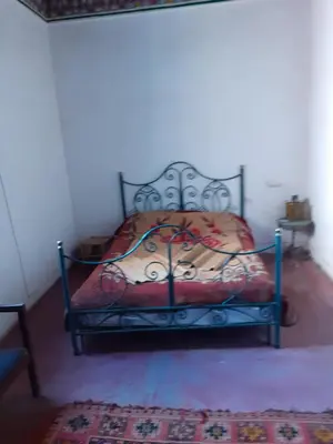 a bedroom with a bed in a room at Maison authentique centre médina in Marrakech