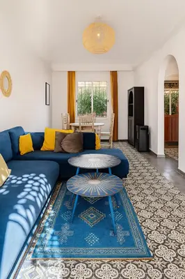 a living room with a blue couch and a table at Villa Kalthoum in Marrakech