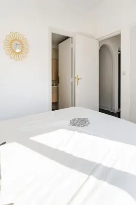 a white bedroom with a large white bed at Villa Kalthoum in Marrakech