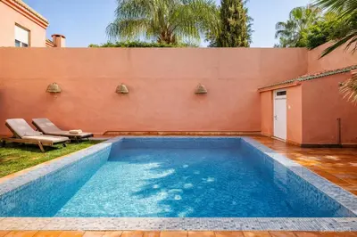 a swimming pool in the backyard of a house at Villa Kalthoum in Marrakech