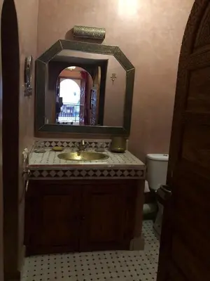 a bathroom with a sink and a mirror at riad rose eternelle in Marrakech