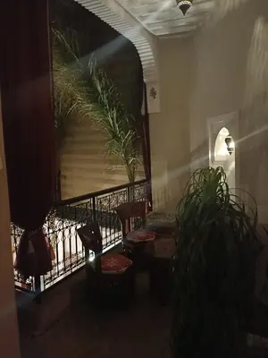 a room with chairs and a balcony with plants at riad rose eternelle in Marrakech