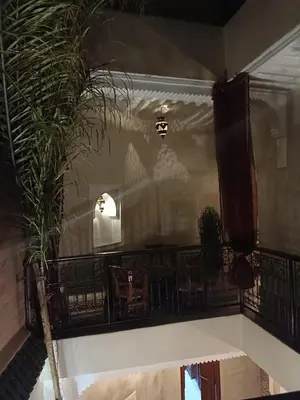 a room with a balcony with a table and chairs at riad rose eternelle in Marrakech