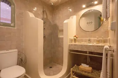 a bathroom with a toilet and a sink and a mirror at Riad Espoir Spa Logement entier in Marrakech