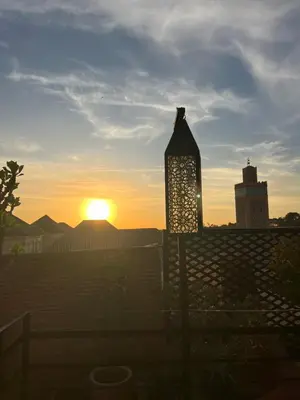 a street light with the sunset in the background at RIAD DAR C in Marrakech