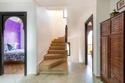 a hallway with stairs leading to a bedroom at Magnifique villa de 320 m2 avec 2 piscines in Marrakech