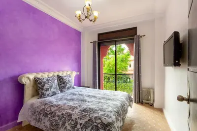a purple bedroom with a bed and a window at Magnifique villa de 320 m2 avec 2 piscines in Marrakech