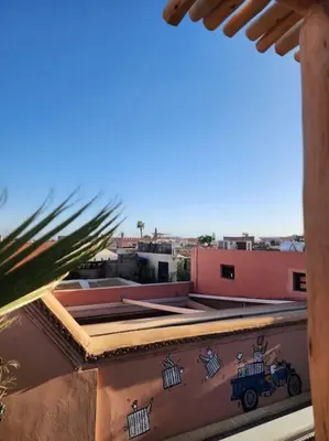 a view from the roof of a building with graffiti at Riad M. Jacuzzi - Piscine Arty/Cosy - Privatif in Marrakech