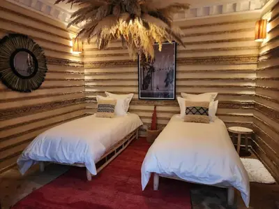 two beds in a room with wooden walls at Riad M. Jacuzzi - Piscine Arty/Cosy - Privatif in Marrakech