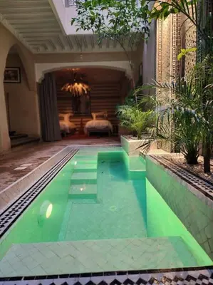 a swimming pool in the middle of a house at Riad M. Jacuzzi - Piscine Arty/Cosy - Privatif in Marrakech