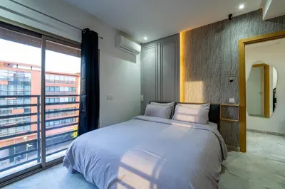 a bedroom with a large bed and a large window at NEW ! Unique Equipped Flat in the Heart of Marrakech in Marrakech