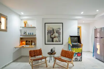 a living room with two chairs and a flat screen tv at NEW ! Unique Equipped Flat in the Heart of Marrakech in Marrakech