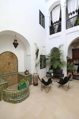 a lobby with chairs and a couch and a table at Riad Noor Charana in Marrakech
