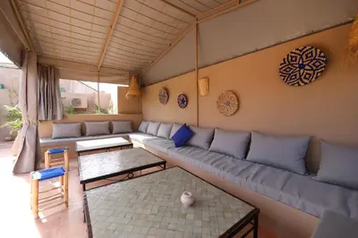 a living room with a couch and a table at Riad Noor Charana in Marrakech