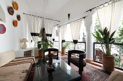a living room with a couch and a glass table at Riad Noor Charana in Marrakech