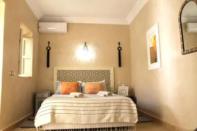 a bedroom with a bed with two towels on it at RIAD TAZZORI in Marrakech