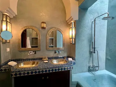 a bathroom with two sinks and a shower at Riad Sassa Finda in Marrakech