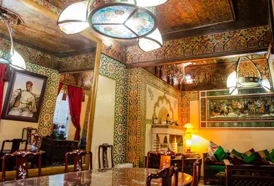 a room with colorful walls and a table and chairs at Riad Esmeralda in Marrakech