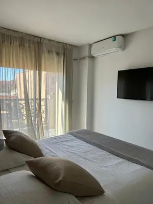 a bedroom with a bed with pillows and a window at Super appartement au cœur de Marrakech in Marrakech