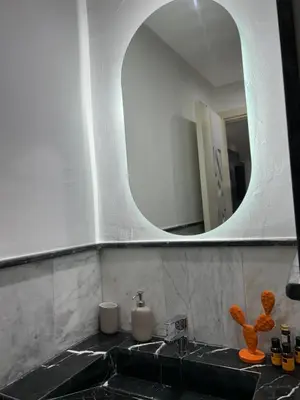 a bathroom with a sink and a mirror at Super appartement au cœur de Marrakech in Marrakech