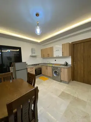 an empty kitchen with a table and a stove at Appartement de luxe Marrakech Gueliz in Marrakech