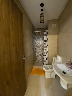 a bathroom with a sink and a toilet and a shower at Appartement de luxe Marrakech Gueliz in Marrakech