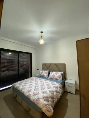 a bedroom with a bed and a window at Appartement de luxe Marrakech Gueliz in Marrakech