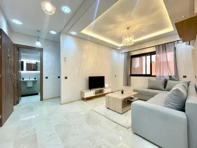 a living room with a couch and a tv at Cozy Apartment in the City Center - 100% Equipped in Marrakech