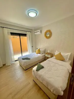 a bedroom with two beds and a window at Cozy Apartment in the City Center - 100% Equipped in Marrakech