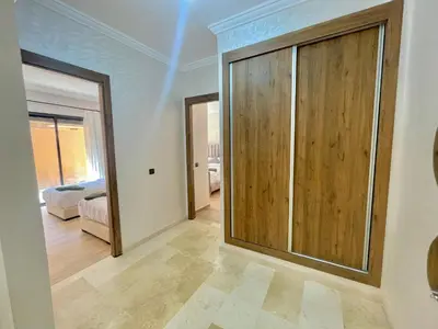 a room with a large wooden door and a bedroom at Cozy Apartment in the City Center - 100% Equipped in Marrakech