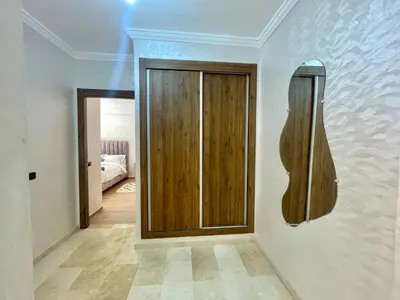 a room with a wooden door on a wall at Cozy Apartment in the City Center - 100% Equipped in Marrakech