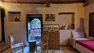 a bedroom with a bed and a dresser and a window at Beldi Riad in Marrakech