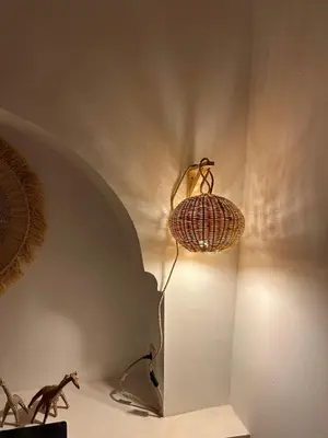 a lamp on a wall next to a wall at Riad Le Manzil Beldi in Marrakech