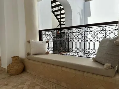 a bench sitting on top of a balcony at Riad Le Manzil Beldi in Marrakech