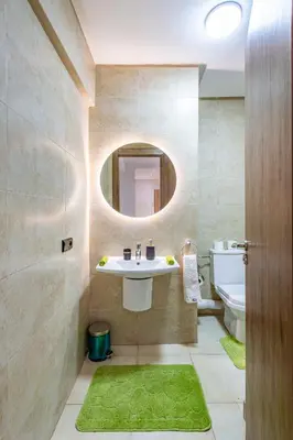 a bathroom with a sink and a mirror at Chic & Cosy Appart au Centre Ville - 100 % Équipé in Marrakech