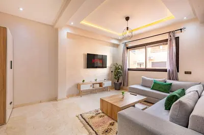 a living room with a couch and a table at Chic & Cosy Appart au Centre Ville - 100 % Équipé in Marrakech