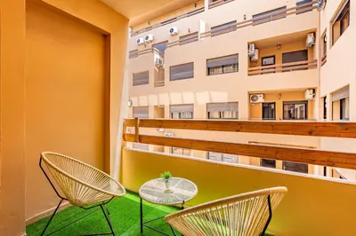 a balcony with two chairs and a table at Jolie & Luxueux Appart a Gueliz - 100% Équipé in Marrakech