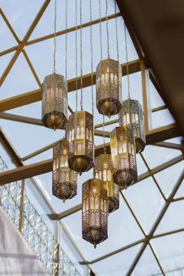 a group of chandeliers hanging from a ceiling at RIAD MARRAKECH DOORS in Marrakech