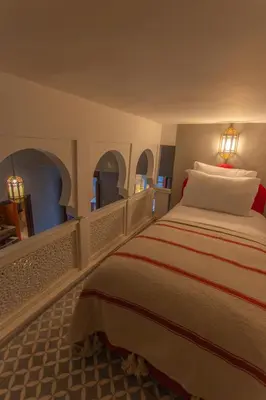 a bedroom with a large bed in a room with arches at RIAD MARRAKECH DOORS in Marrakech