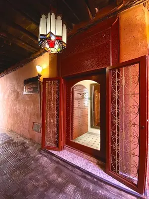 a room with a mirror and a window and a light at RIAD MARRAKECH DOORS in Marrakech