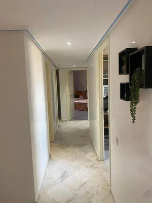 a hallway leading to a room with a hallway at Appartment le bleu in Marrakech