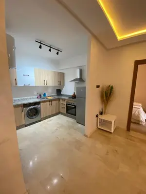 a large kitchen with a washer and dryer at Superbe appartement uniquement pour les familles in Marrakech